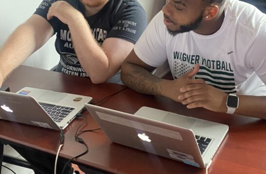 Two AusomeTech students studying on a Mac Laptop